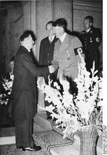 British Prime Minister Neville Chamberlain cheerfully greeted by Adolf Hitler at the beginning of the Bad Godesberg meeting on 24 September 1938, where Hitler demanded annexation of Czech border areas without delay