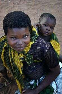 Bien que la figure d'attachement primaire est habituellement la mère, les bébés forment des liens d'attachement avec toute personne prenant soin d'eux et répondant à leur demande d'interactions sociales. Photo prise à Nampula au Mozambique en septembre 2005.