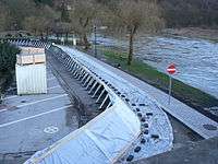 Exemple de barrière légère destinée à protéger provisoirement et en urgence contre l'inondation, plus ou moins efficacement selon la nature du sol et le périmètre à protéger.